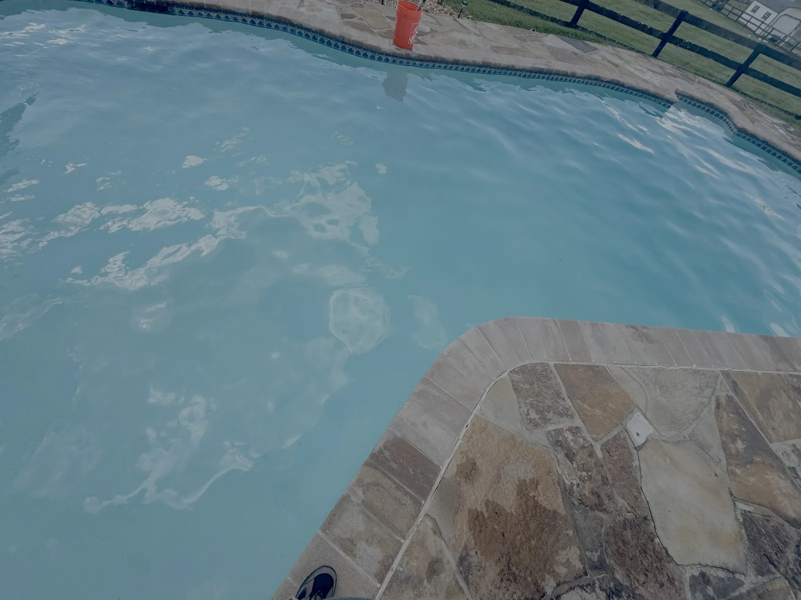 Flagstone patio and pool maintained on a weekly service plan