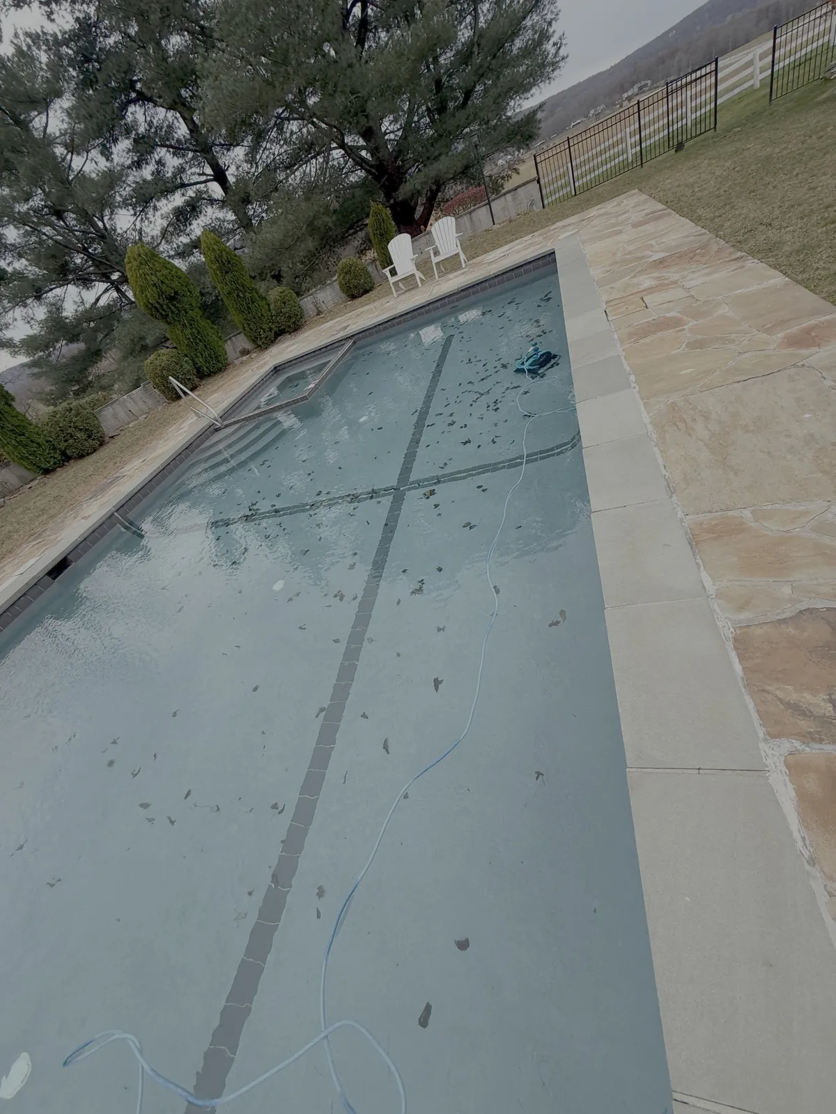 Rectangular in-ground pool during a routine maintenance visit