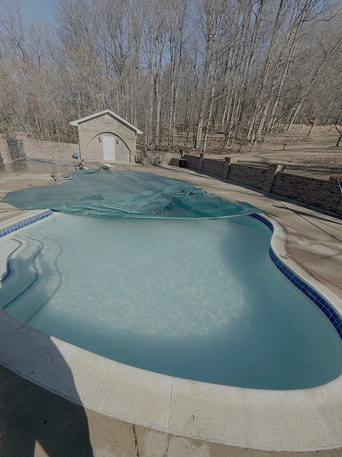 Pool cover removal during a spring pool opening service